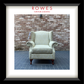 Decorative armchair in front of a brick wall with 'Rowes Furniture & Bedding' branding.