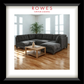 A Dark sofa in a well lit room with a coffee table