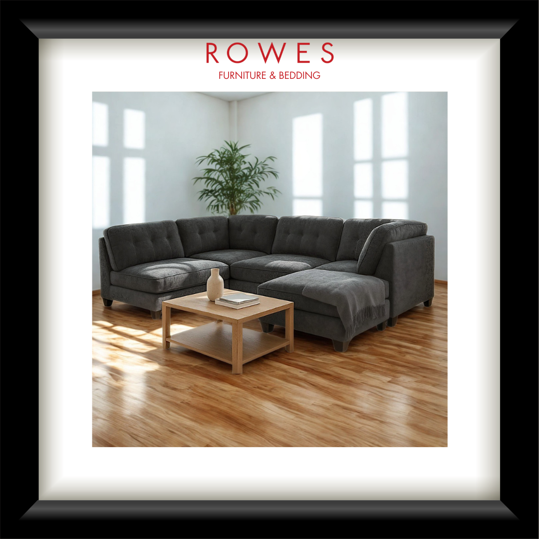 A Dark sofa in a well lit room with a coffee table