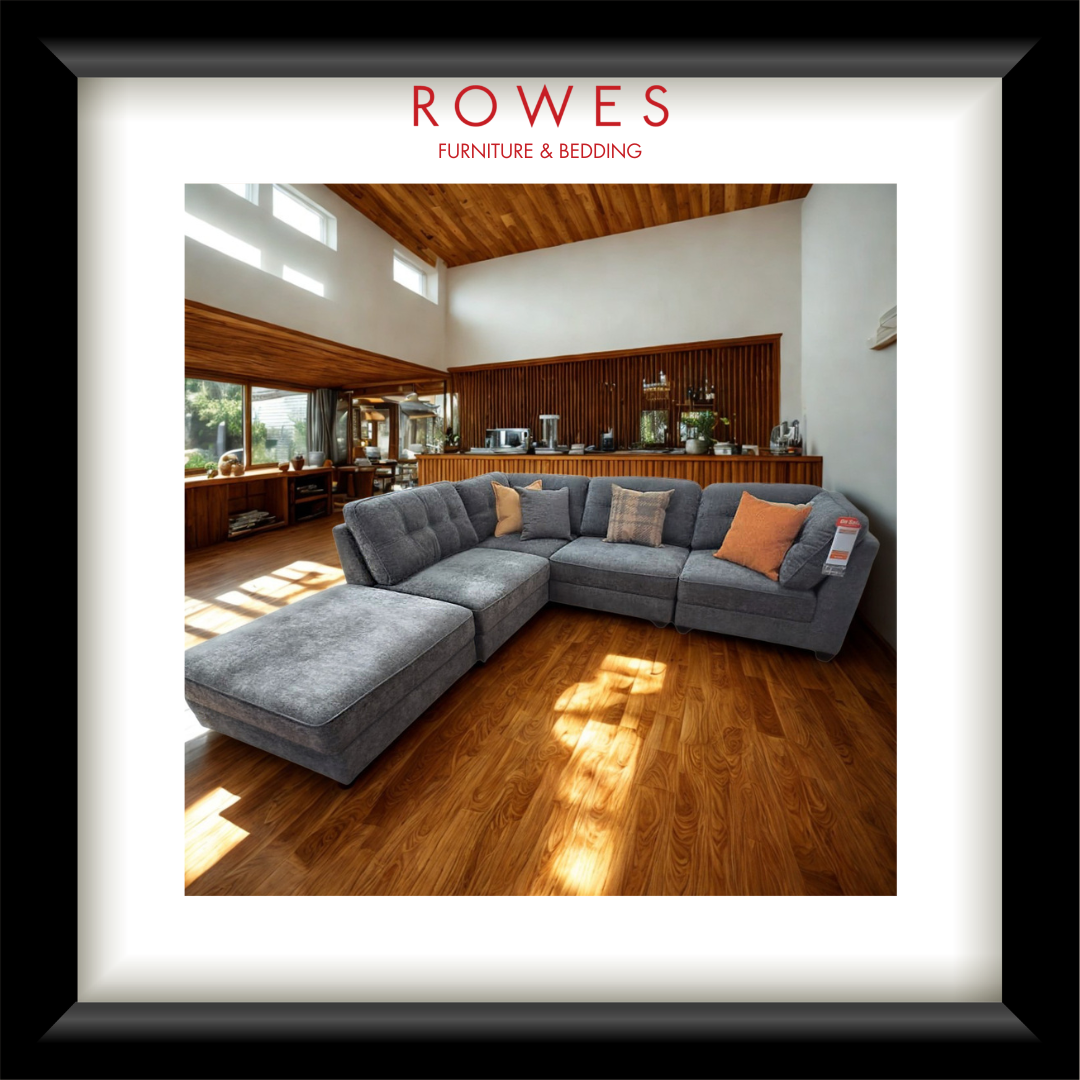 A large room with a grey sofa and ottoman