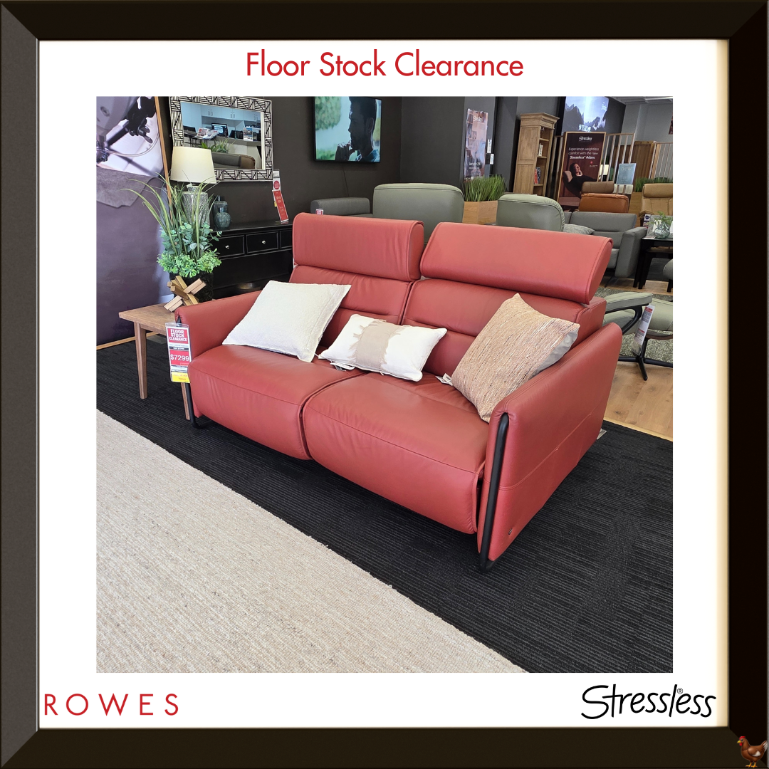 Red sofa with cushions in a room setting, featuring 'Rowes' and 'Stressless' branding.