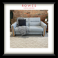 Gray sofa with decorative pillows and a blanket on a rug, against a brick wall with 'Rowes Furniture & Bedding' branding.