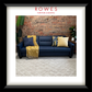 Blue sofa with decorative pillows and a yellow blanket against a brick wall, branded 'Rowes Furniture & Bedding'.