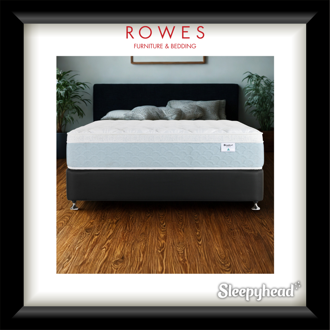 White mattress on a bed frame with 'Rowes Furniture & Bedding' and 'Sleepyhead' branding.
