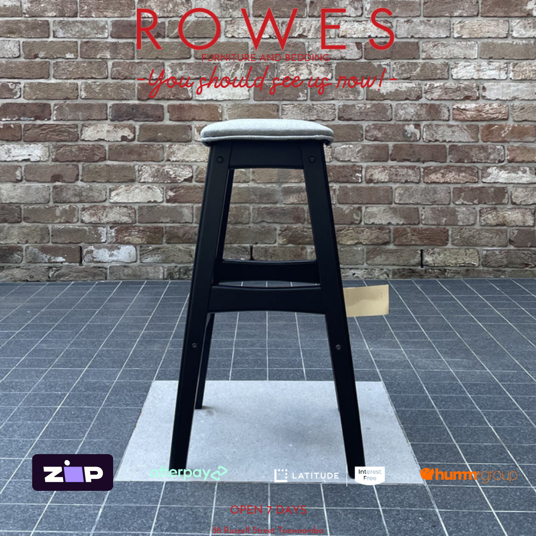 Black stool against a brick wall with 'ROWES' branding and various logos at the bottom.