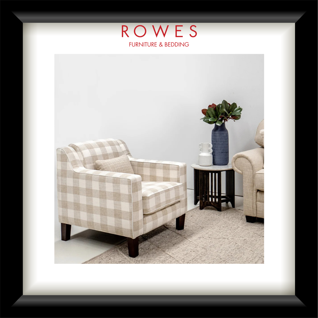 Plaid armchair in a room with a vase of flowers, featuring Rowes Furniture & Bedding logo.