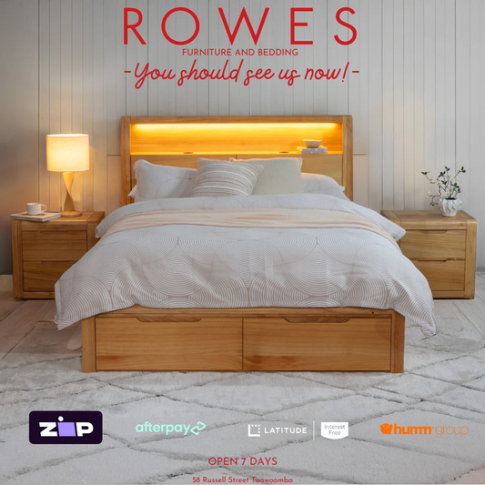 Wooden bed with bedding in a bedroom setting, featuring 'Rowes Furniture and Bedding' advertisement.