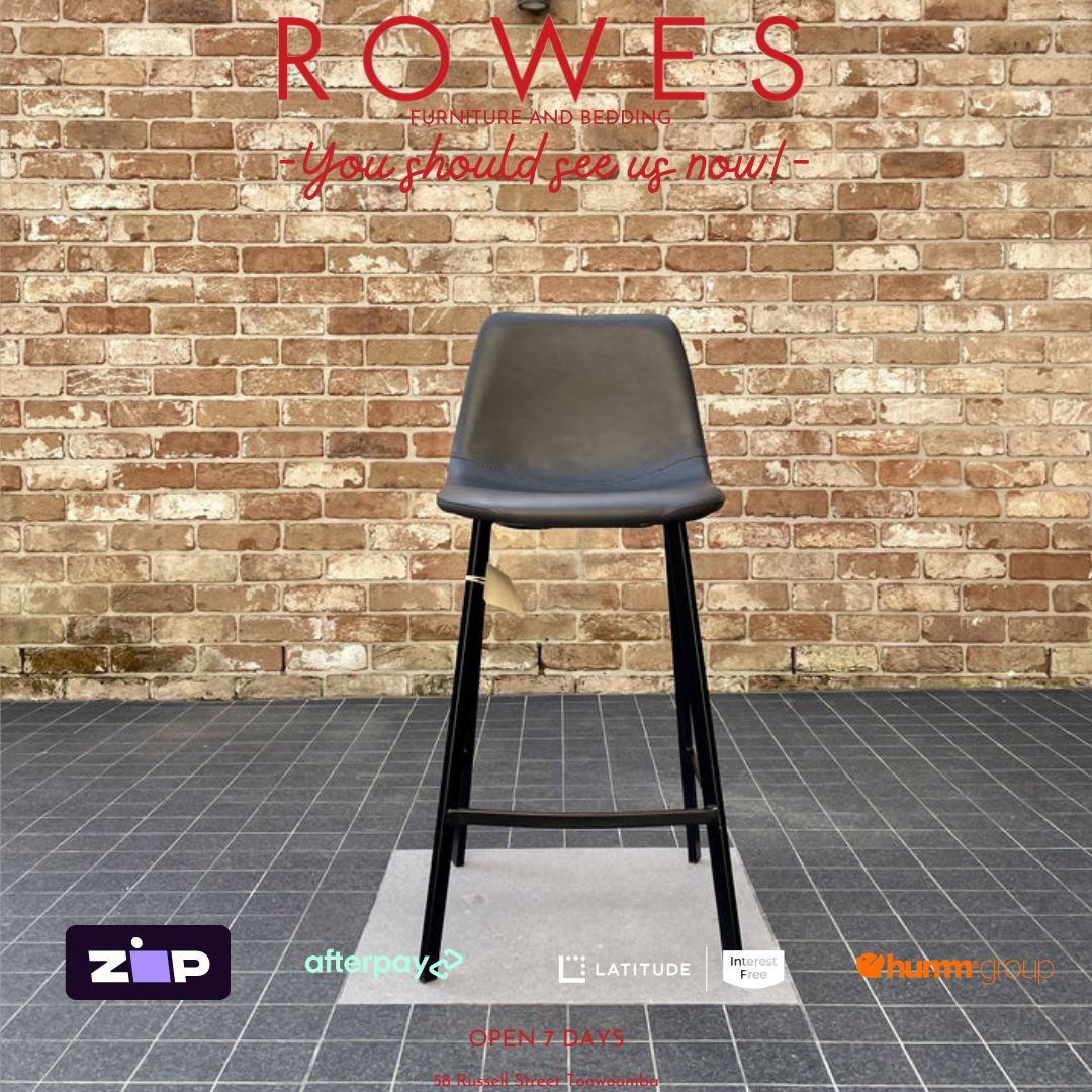Black stool against a brick wall with 'Rowes' branding.