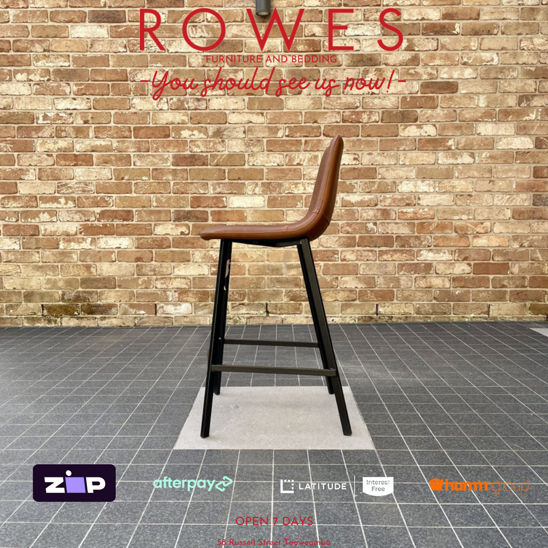 Brown bar stool against a brick wall with promotional text for ROWES.