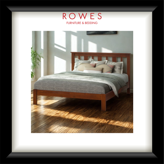 Wooden bed with gray bedding in a bright room, featuring Rowes Furniture & Bedding logo.