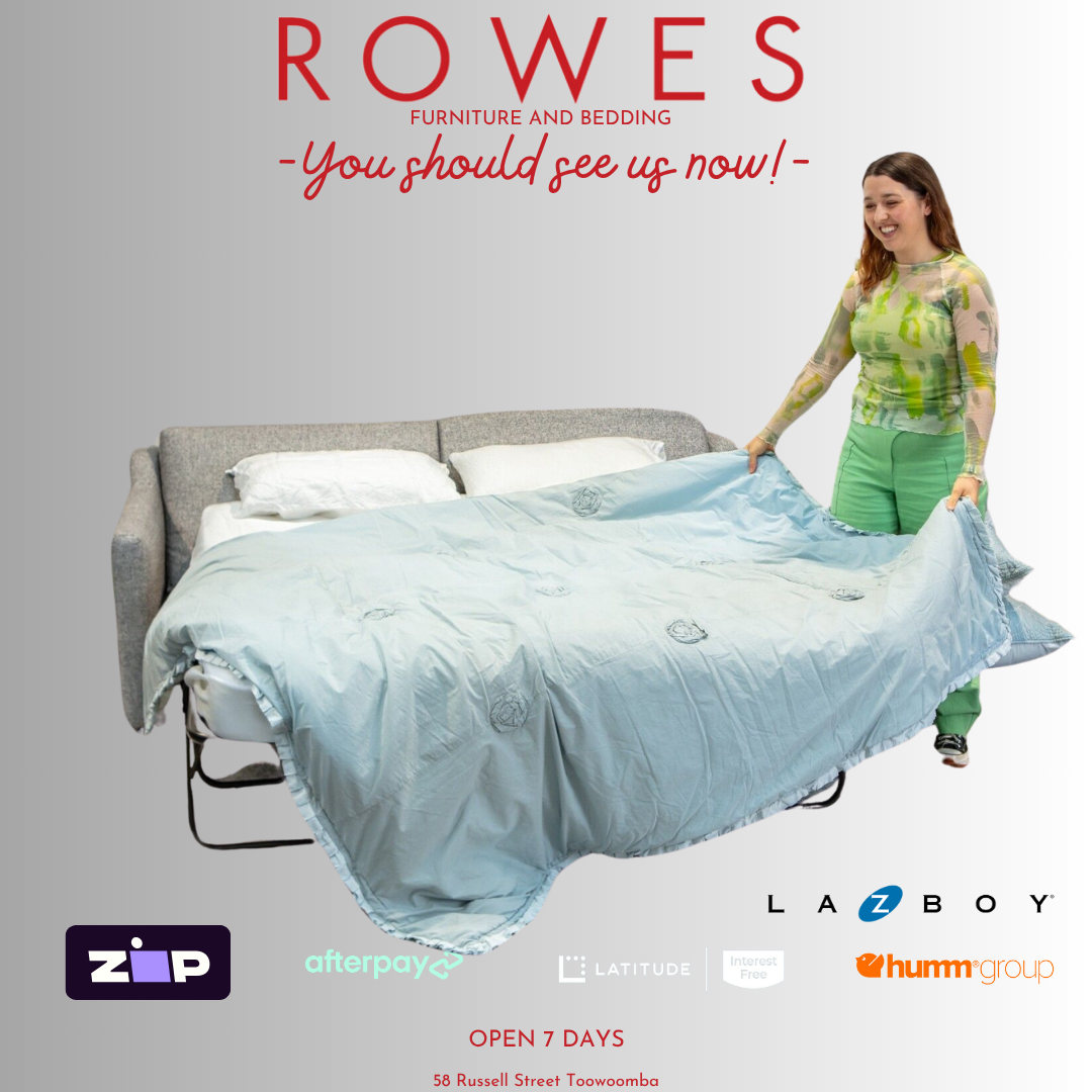Woman spreading a blanket on a gray sofa bed with 'Rowes Furniture and Bedding' branding.