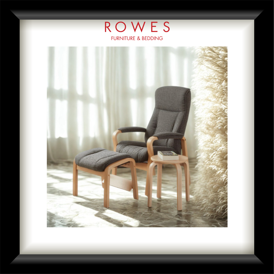 Gray armchair with ottoman and small table in a bright room with curtains, featuring 'Rowes Furniture & Bedding' branding.
