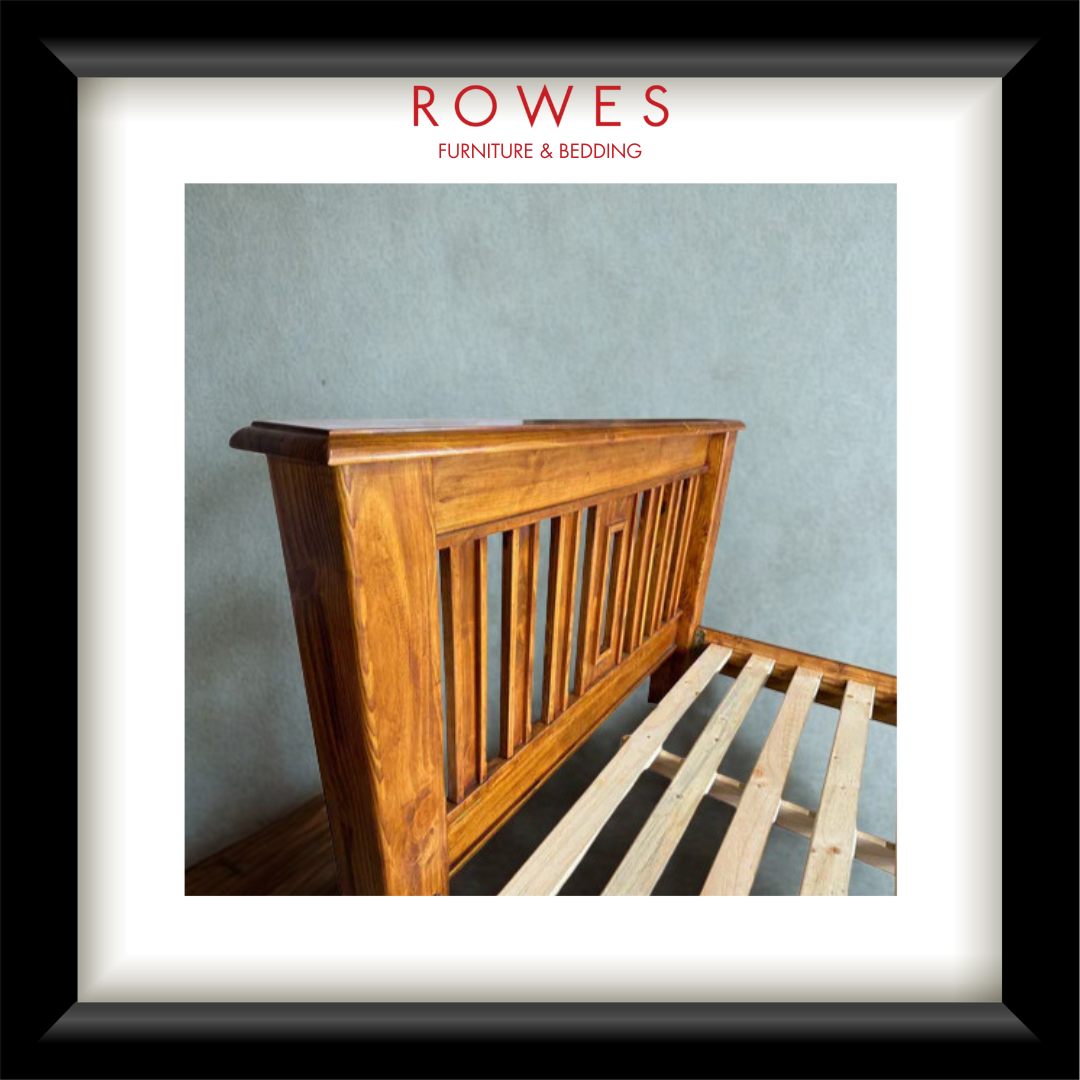 A large timber bed in a well lit room with the Rowes branding