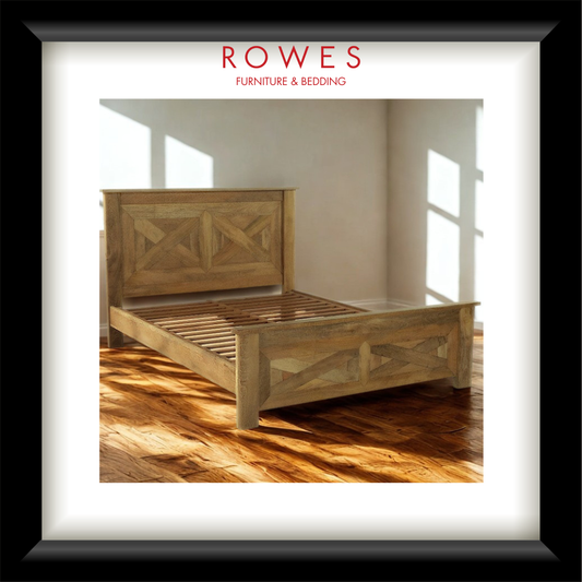 Wooden bed with intricate designs in a room with wooden flooring and large windows, featuring the Rowes Furniture & Bedding logo.