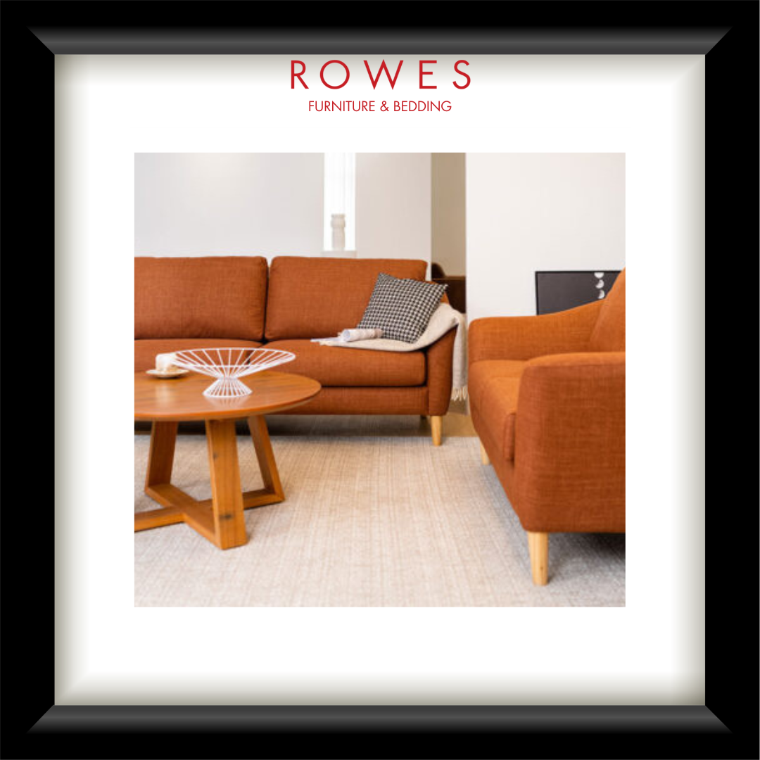 Living room with brown sofa and coffee table, featuring Rowes Furniture & Bedding logo.
