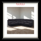 Black sectional sofa in a room with sunlight filtering through windows, branded 'Rowes Furniture & Bedding'.