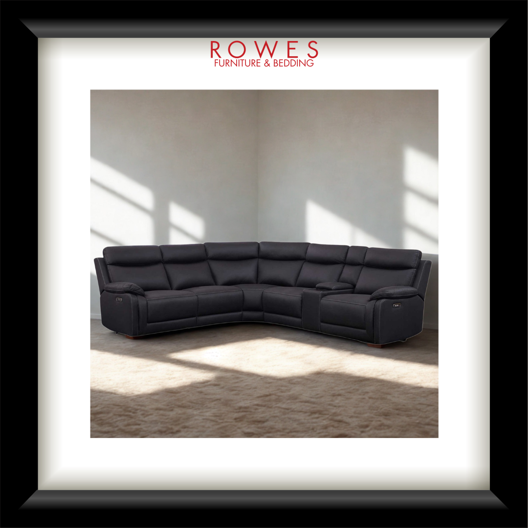 Black sectional sofa in a room with sunlight filtering through windows, branded 'Rowes Furniture & Bedding'.