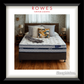 Bed with pillows and blankets on a wooden floor, featuring Rowes Furniture & Bedding branding.