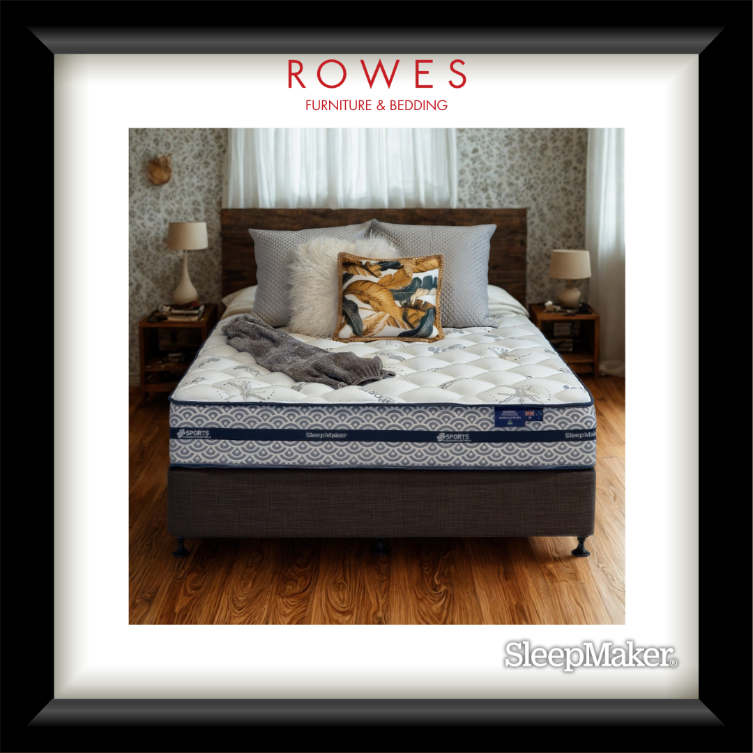 Bed with pillows and blankets on a wooden floor, featuring Rowes Furniture & Bedding branding.