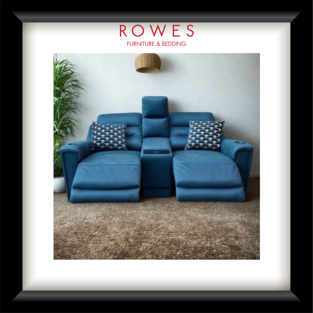 Blue sofa with decorative pillows in a room setting, featuring the Rowes Furniture & Bedding logo.