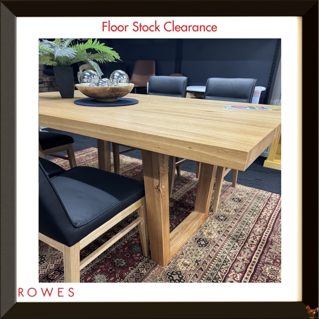 The image shows a framed photo of a large dining table with a loop leg and surrounded by leather dining chairs, featuring the Rowes logo