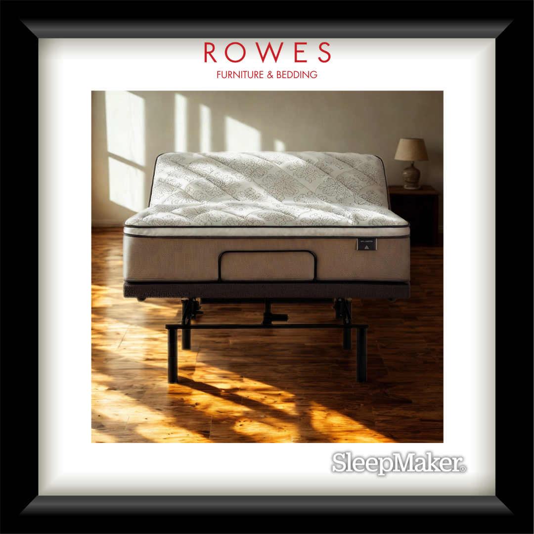Mattress on a stand with 'Rowes Furniture & Bedding' branding in a room with wooden floor and lamp.