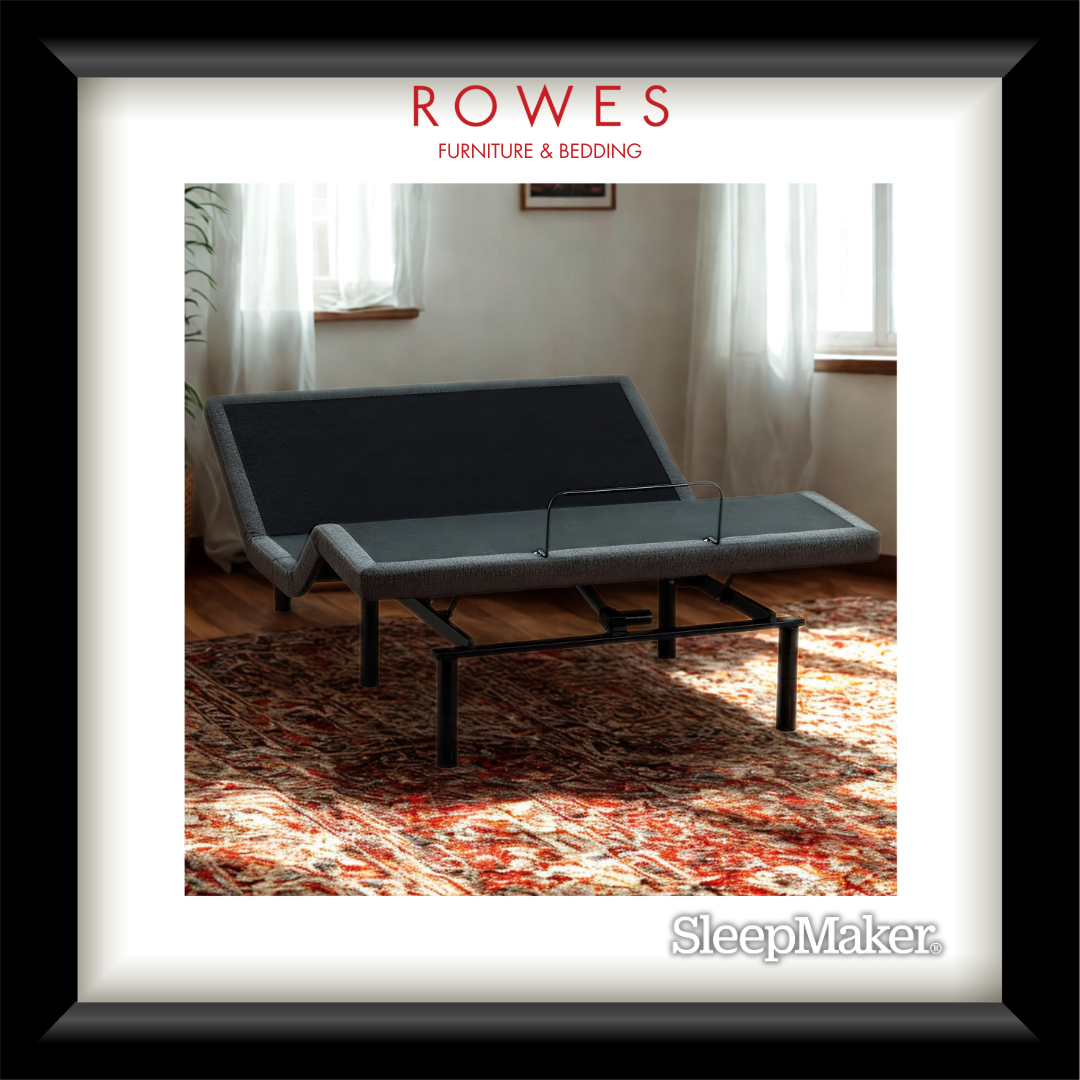 Gray adjustable bed in a room with curtains and a rug, featuring 'Rowes Furniture & Bedding' and 'SleepMaker'.