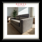 Gray sofa in a living room with 'Rowes Furniture & Bedding' branding.