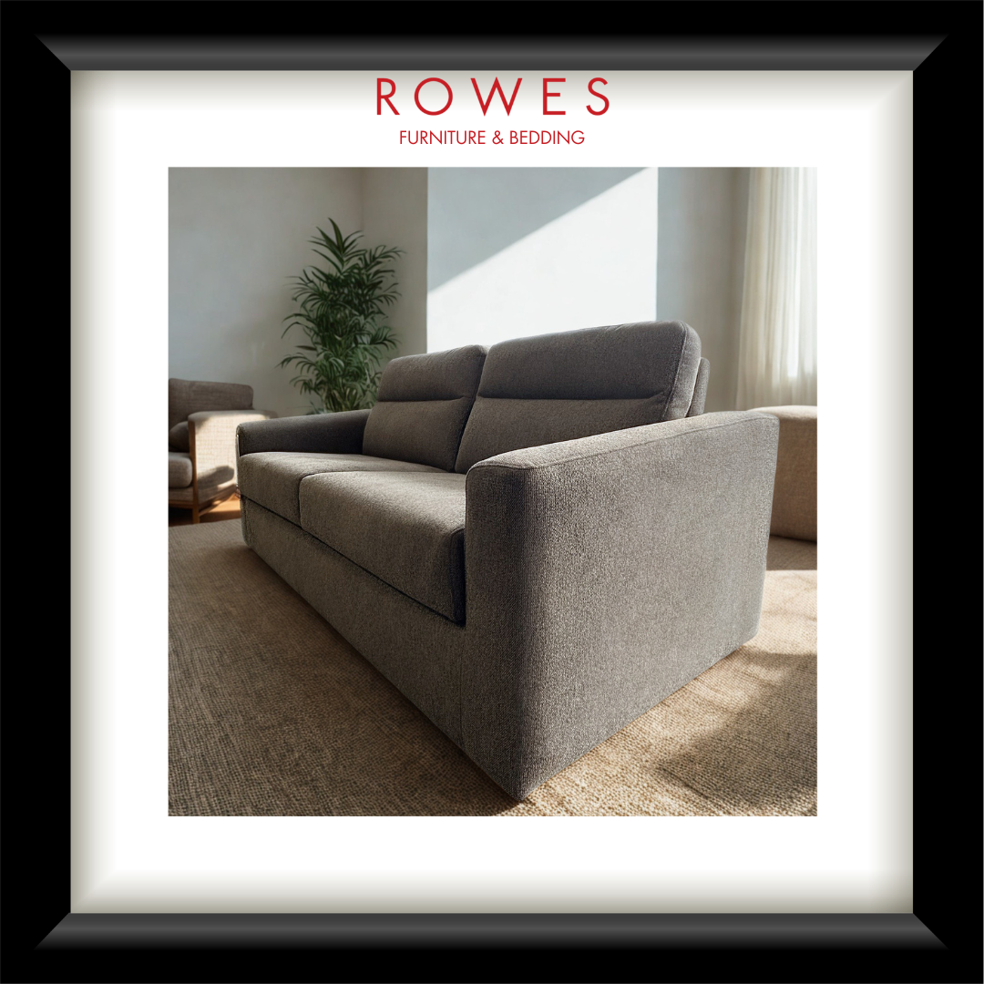 Gray sofa in a living room with 'Rowes Furniture & Bedding' branding.