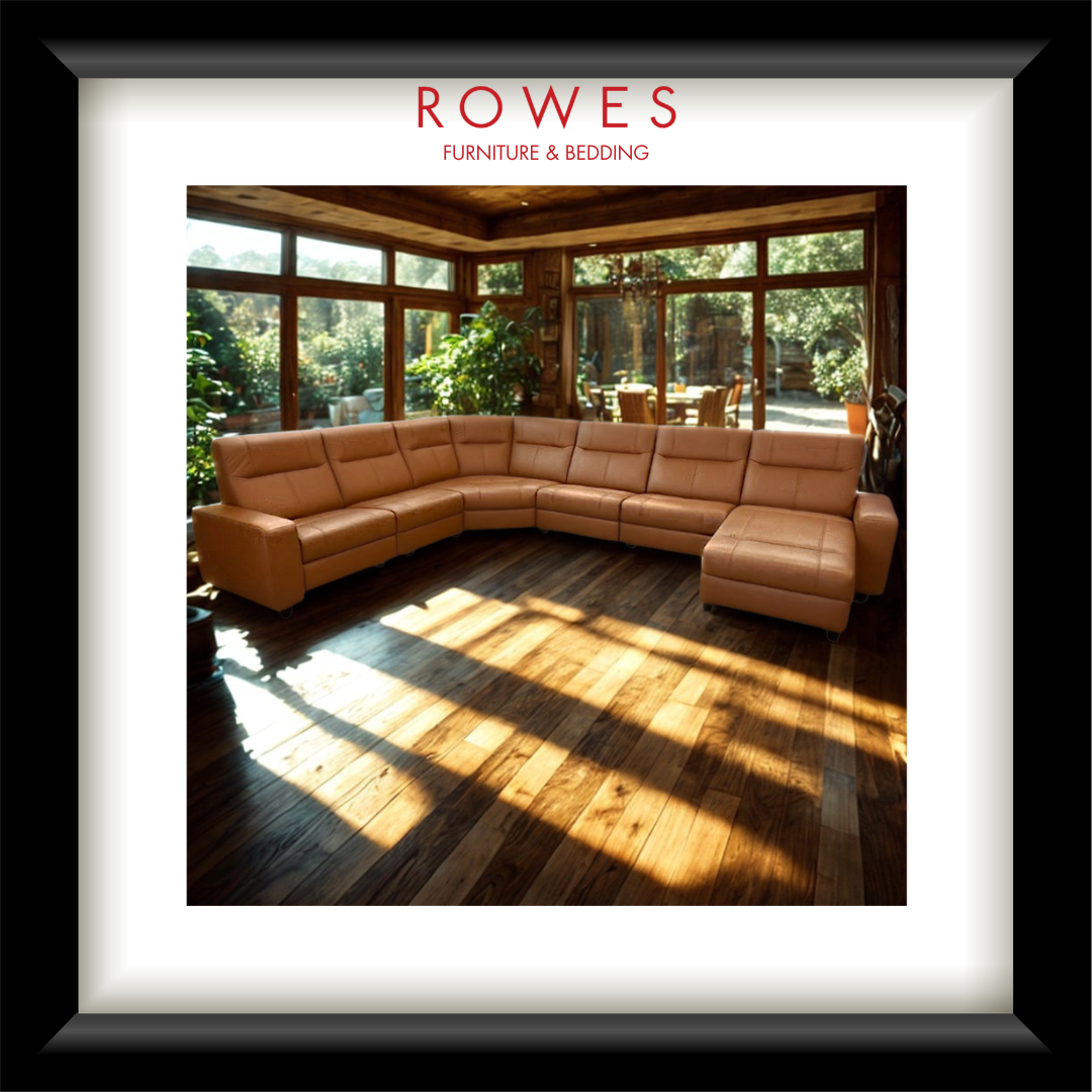 Brown leather sectional sofa in a room with large windows, featuring 'Rowes Furniture & Bedding' branding.