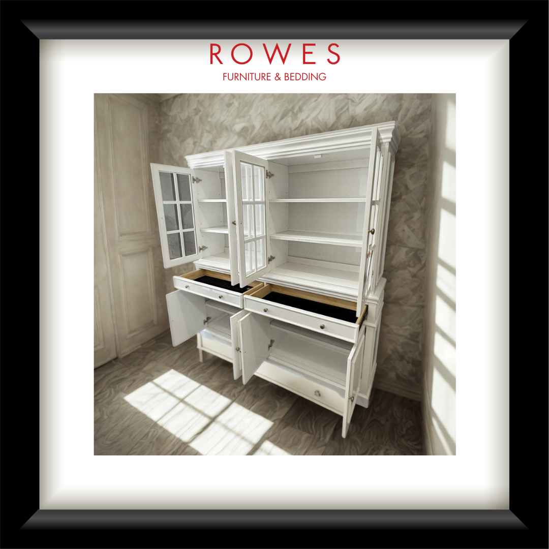 A framed product image of a white wooden buffet and hutch with open doors and drawers, set against a textured gray wall. The image is framed with a white mat and a black frame, with the brand name 'ROWES FURNITURE & BEDDING' printed at the top.