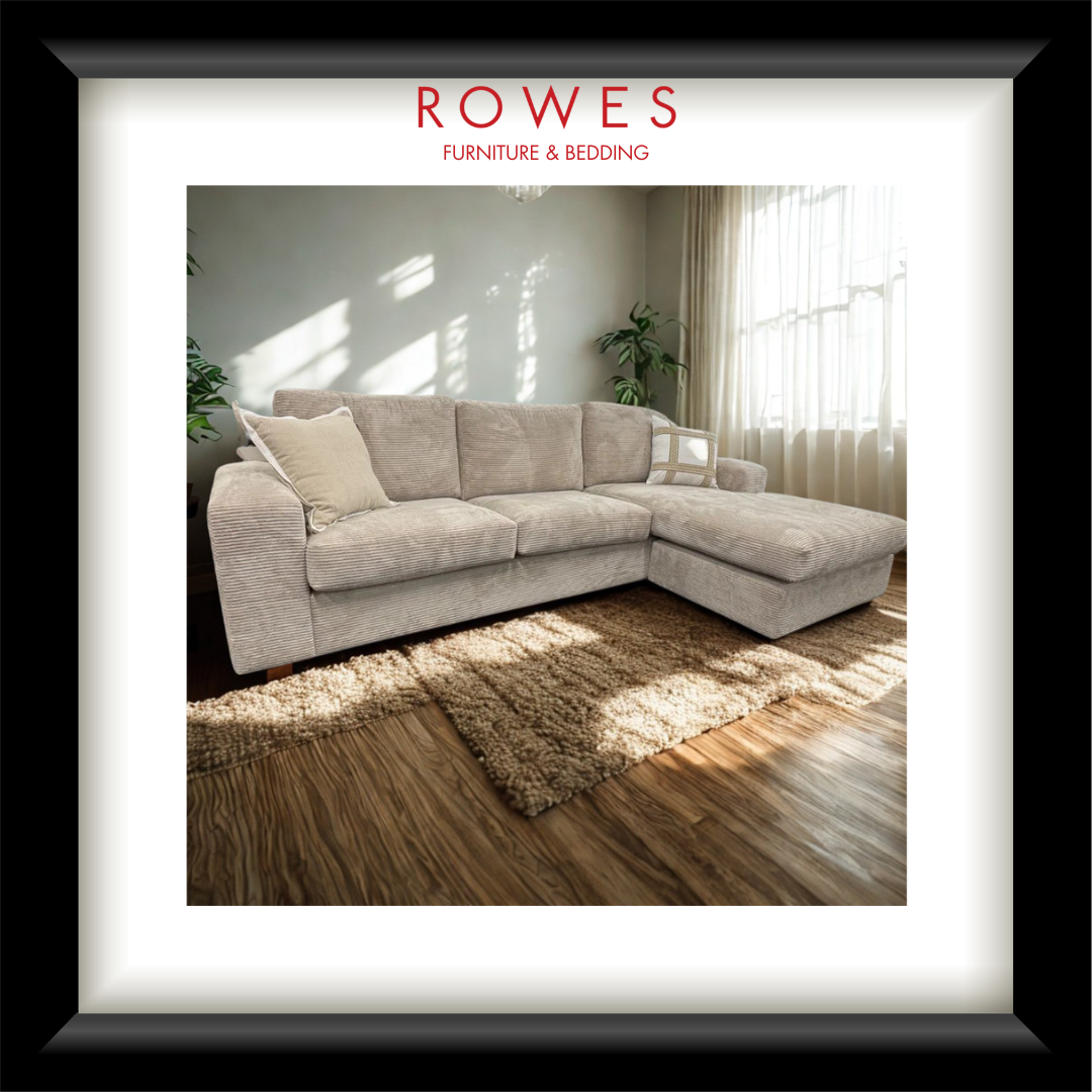 Beige sectional sofa in a room with sunlight filtering through curtains, featuring 'Rowes Furniture & Bedding' branding.