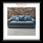 Blue sofa with cushions against a brick wall, featuring 'Rowes Furniture & Bedding' logo.