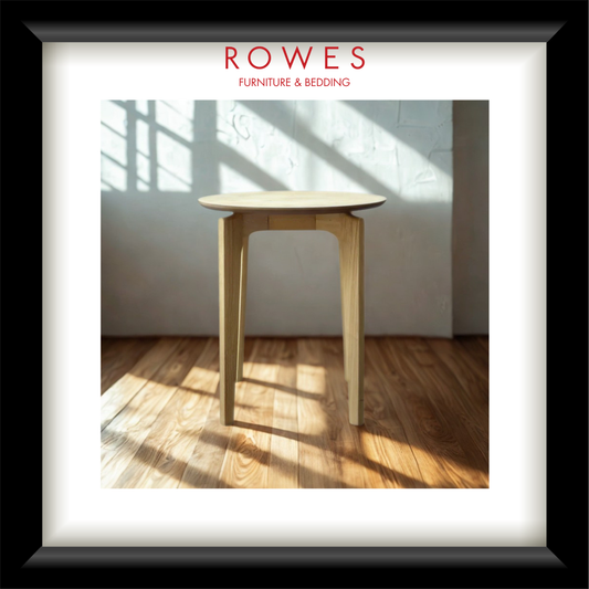 A lamp table in a well lit room on a timber floor with the Rowes branding