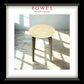 A lamp table in a well lit room on a timber floor with the Rowes branding