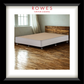 Bed with wooden headboard on a wooden floor, featuring ROWES Furniture & Bedding logo.