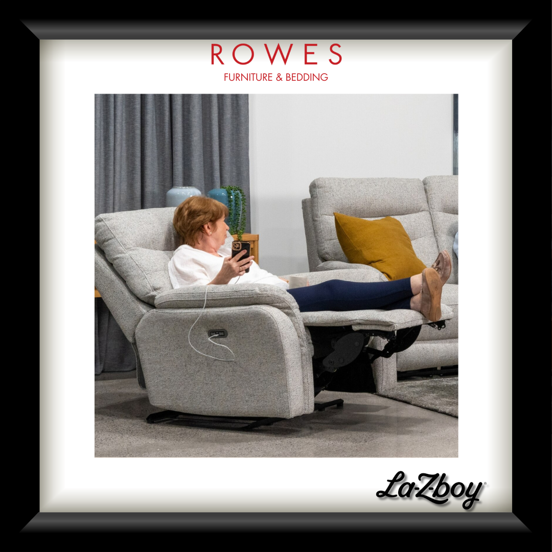 Person using a smartphone in a recliner chair with 'Rowes Furniture & Bedding' and 'LaZboy' branding.