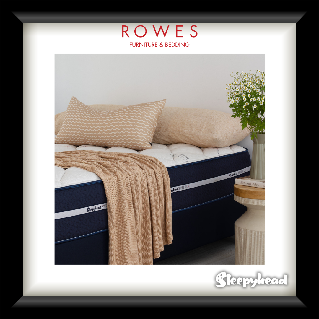 Bed with beige bedding and pillows, featuring Rowes Furniture & Bedding logo.