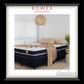 Navy blue mattress with beige bedding in a bedroom setting, featuring Rowes Furniture & Bedding branding.