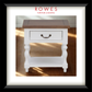 Wooden side table with white base and brown top on a wooden floor, branded 'Rowes'.