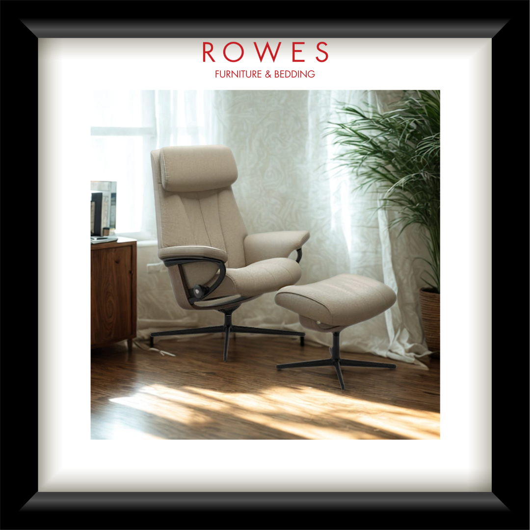 Beige recliner chair with ottoman in a room with curtains and a plant, featuring 'Rowes Furniture & Bedding' logo.