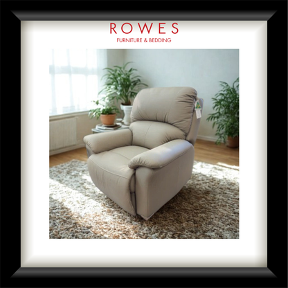 Beige recliner chair in a room with plants and sunlight, featuring 'Rowes Furniture & Bedding' logo.