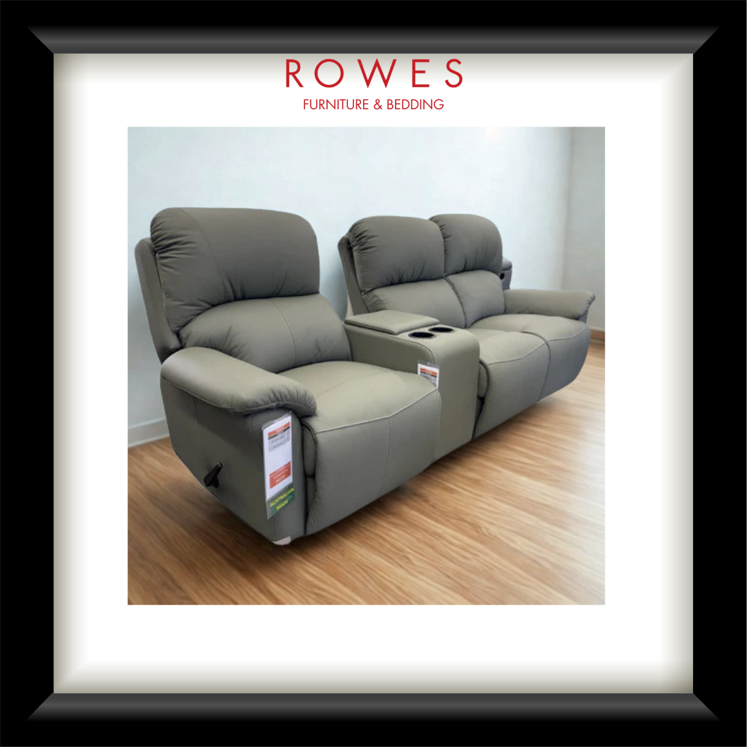 Gray recliner sofa on a wooden floor with 'Rowes Furniture & Bedding' branding.