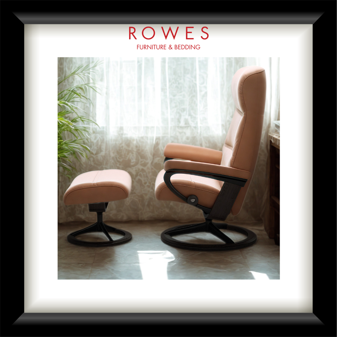 Pink armchair with ottoman in a room with curtains and plants, featuring 'Rowes Furniture & Bedding' logo.