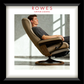Man relaxing in a modern recliner chair with 'Rowes Furniture & Bedding' branding.