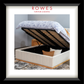A bedroom scene featuring a large, plush bed with a fabric bedhead and foot, bedsides and a large rug. The bed is up and open, demonstrating the storage hidden underneath the bed. The Rowes Furniture logo features