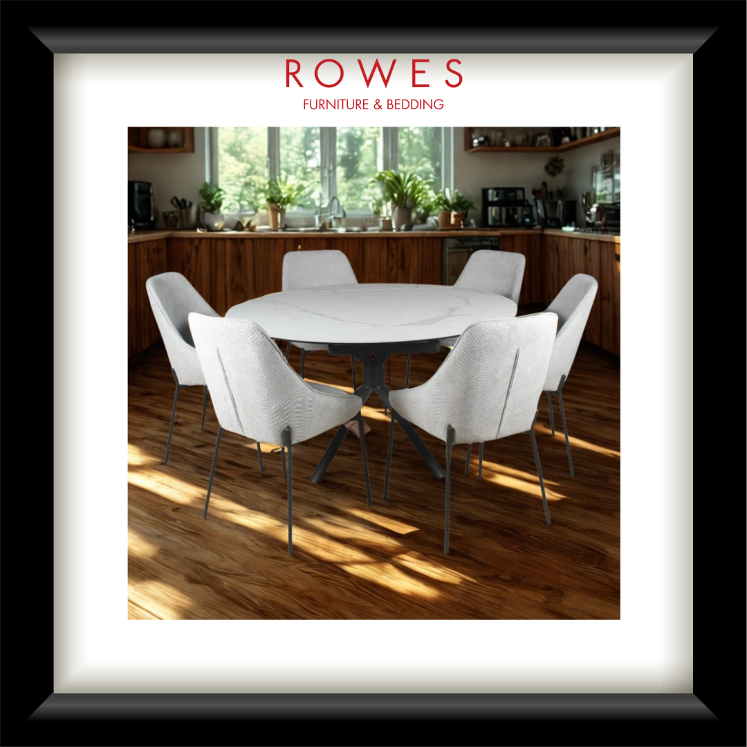 Dining room with a round table and white chairs, featuring Rowes Furniture & Bedding logo.