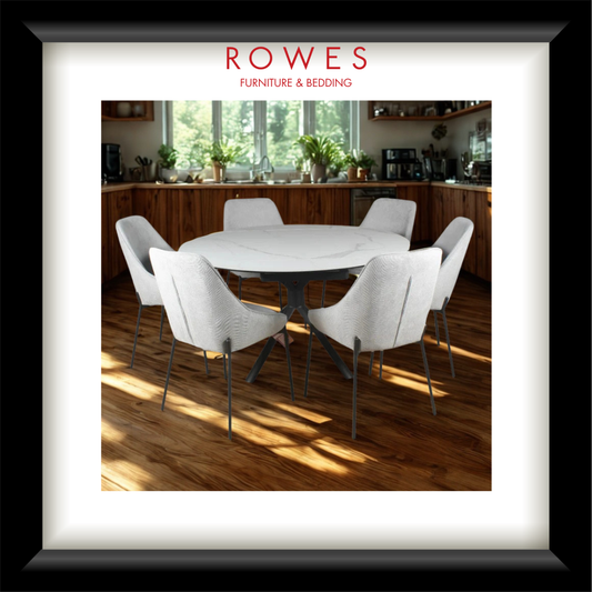 Dining room with a round table and white chairs, featuring Rowes Furniture & Bedding logo.