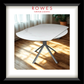 White dining table with gray legs on a wooden floor, branded as Rowes Furniture & Bedding.