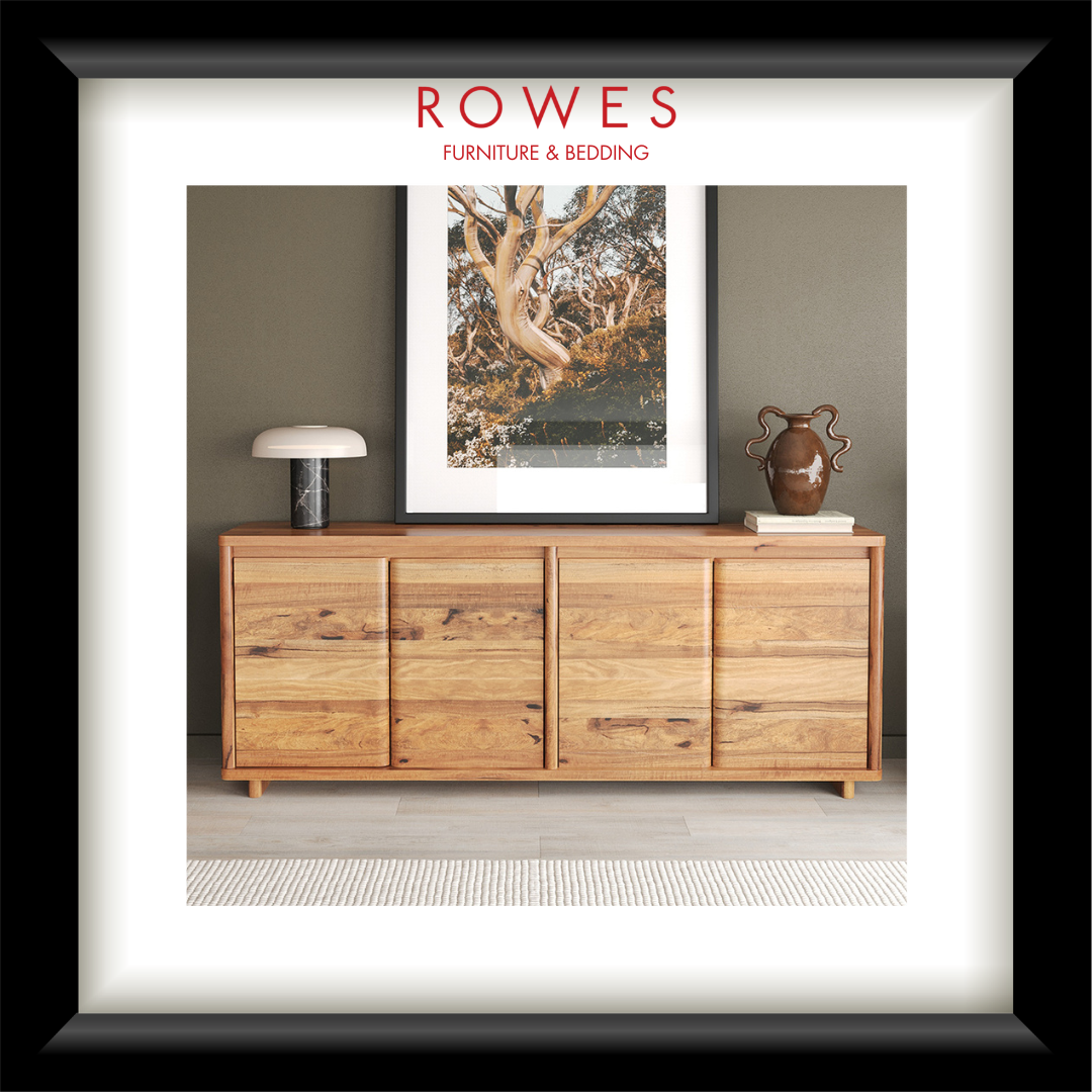 Wooden sideboard with decorative items against a wall, featuring Rowes Furniture & Bedding logo.